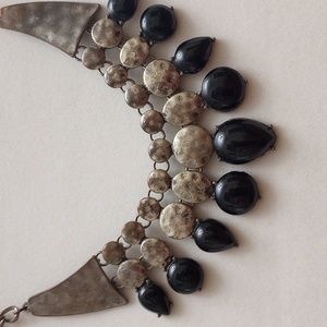 Silver metal and black necklace.